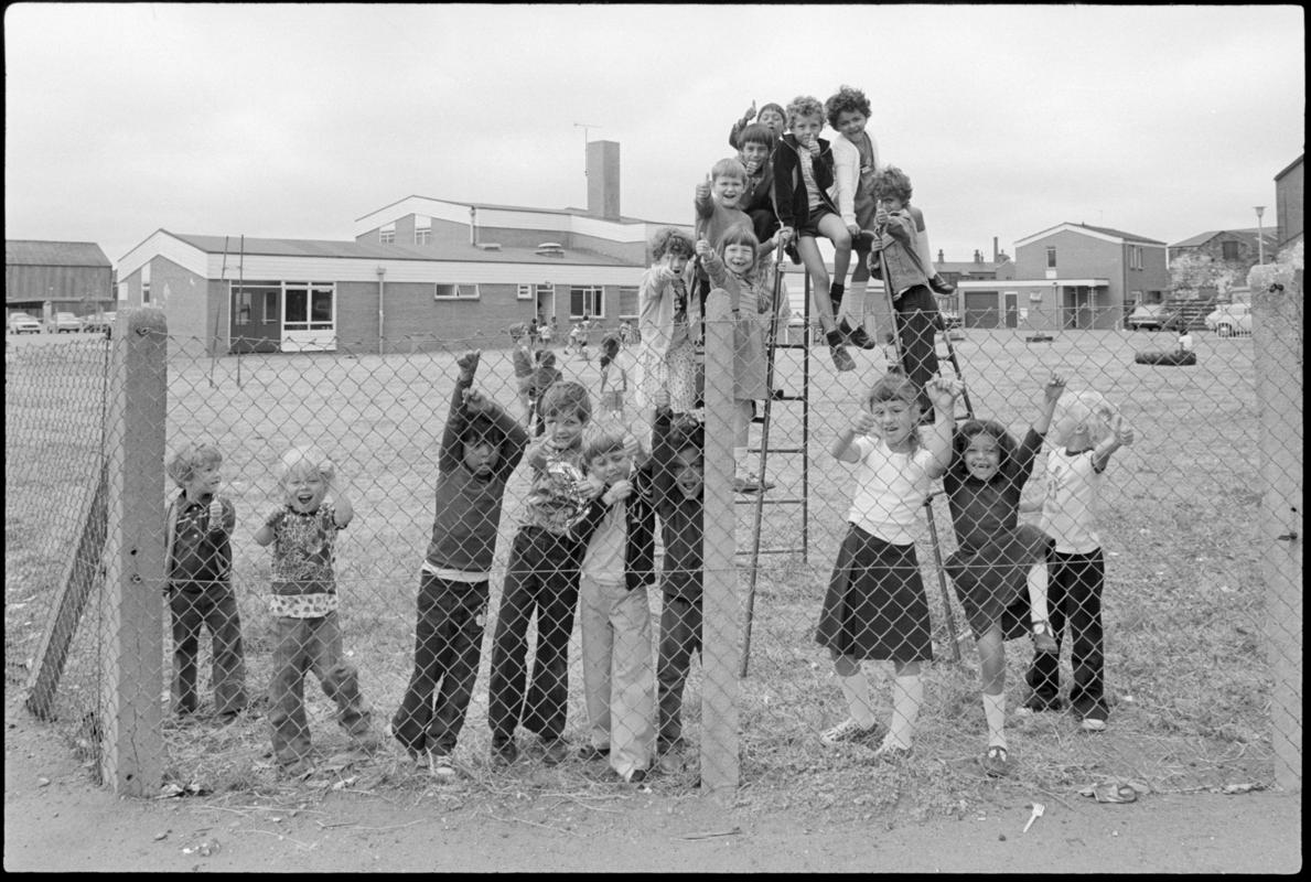 School children on climbing frame in the playground with Mountstuart Primary School in the background.