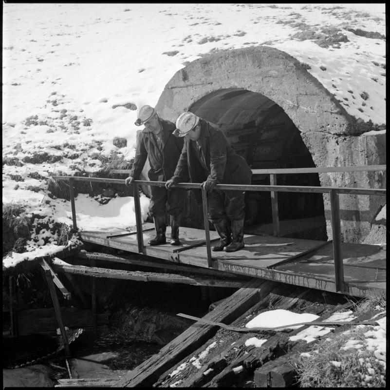 Black and white film negative showing two men at River Arch, Big Pit Colliery.  &#039;River Arch Blaenavon&#039; is transcribed from original negative bag.