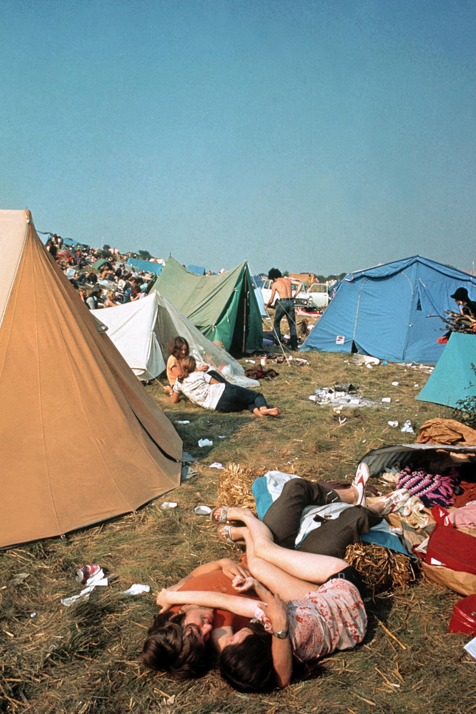 Isle of Wight Festival. A couple waking up after a night huddling together to keep warm