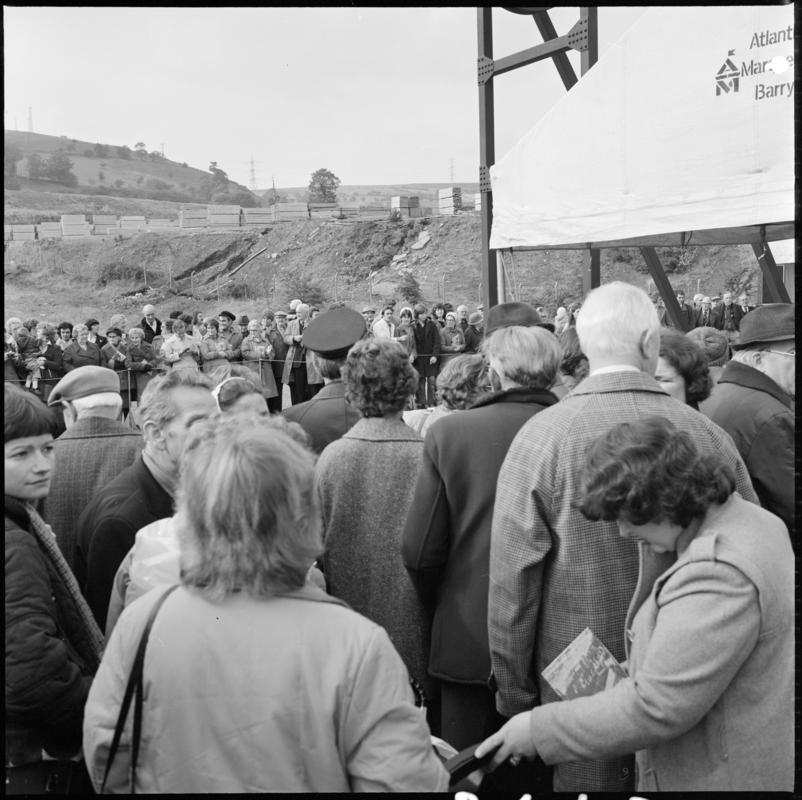 Black and white film negative showing the unveiling ceremony of the Senghenydd memorial, commemorating the 1913 Universal Colliery explosion.  The negative is undated but the ceremony took place in October 1981. &#039;Senghenydd&#039; is transcribed from original negative bag.