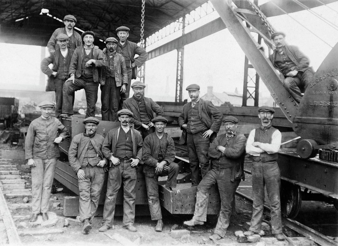 Group of 14 workers, possibly showing maintainance men at Dyffryn steel and tinplate works.