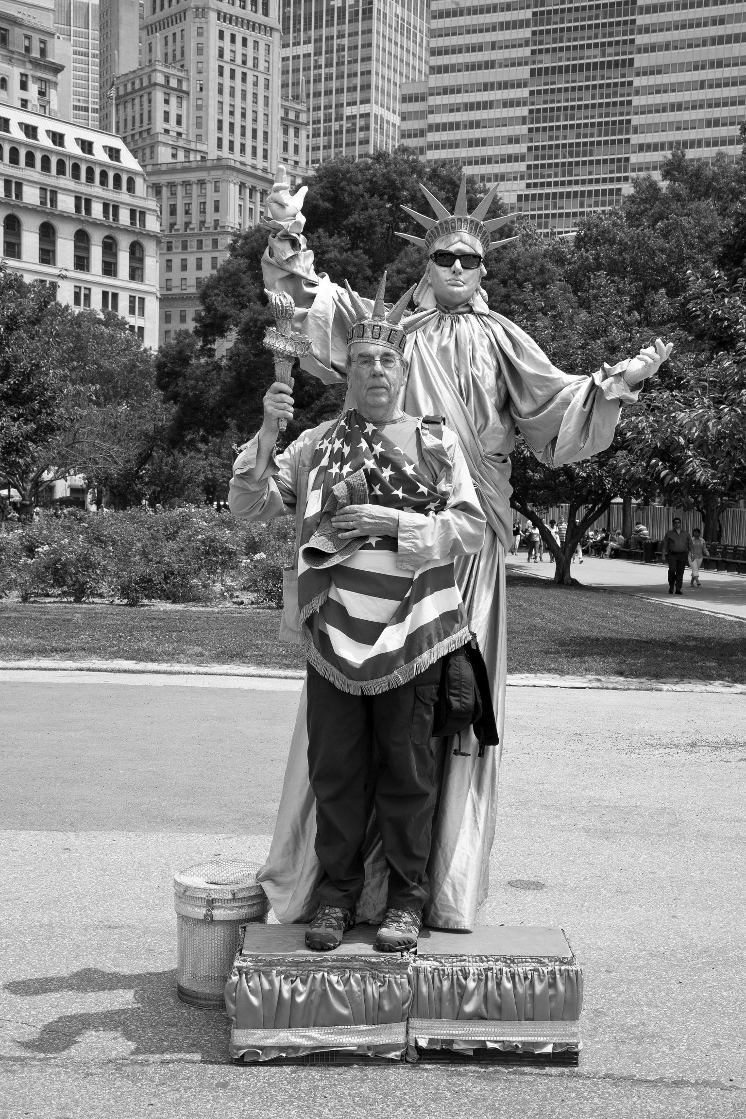 Photographer David Hurn poses with Statue of Liberty in Battery Park. New York USA