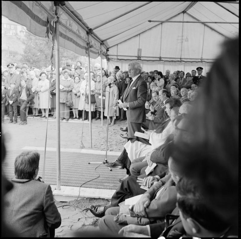 Black and white film negative showing the unveiling ceremony of the Senghenydd memorial, commemorating the 1913 Universal Colliery explosion.  The negative is undated but the ceremony took place in October 1981.  &#039;Senghenydd&#039; is transcribed from original negative bag.