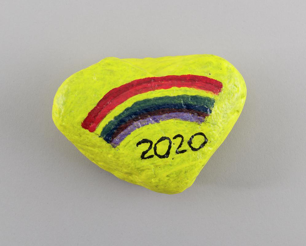 Painted pebble / stone with 2020 and a rainbow on a yellow background
