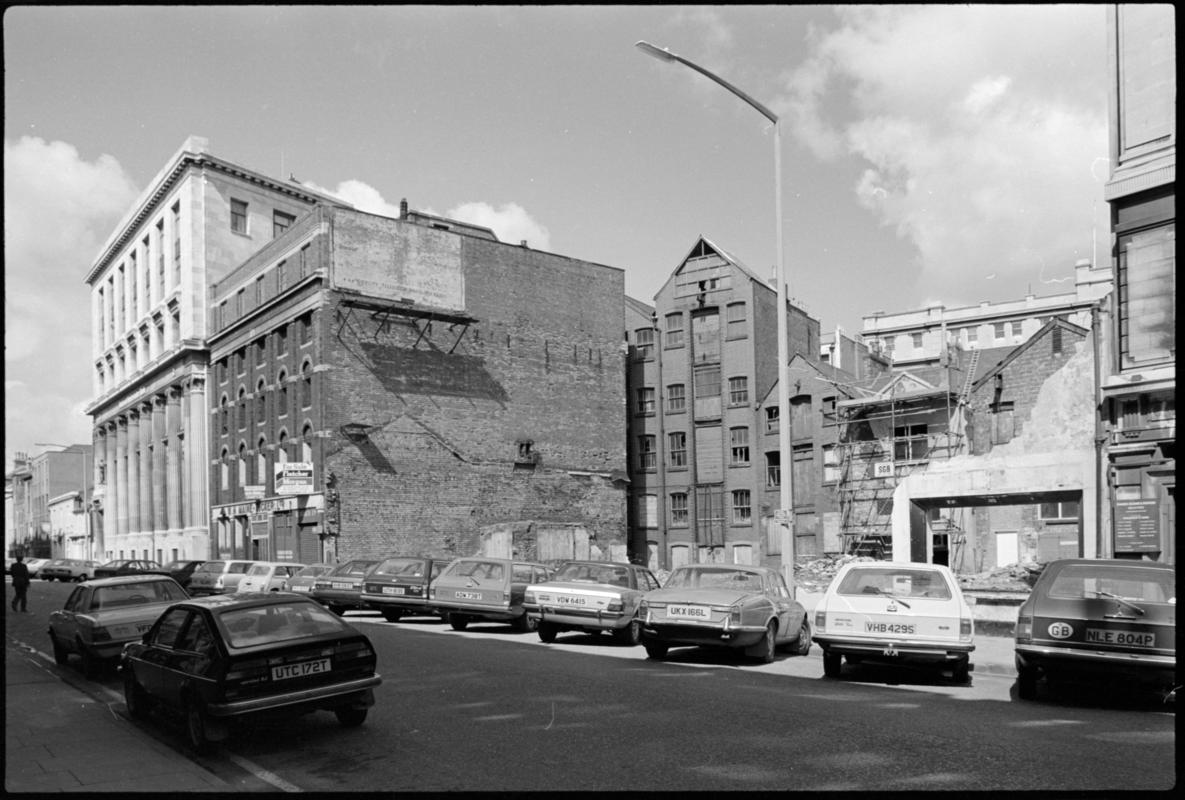 Exterior view of National Westminster Bank, contrasting with old and partly demolished buildings in West Bute Street, Butetown.