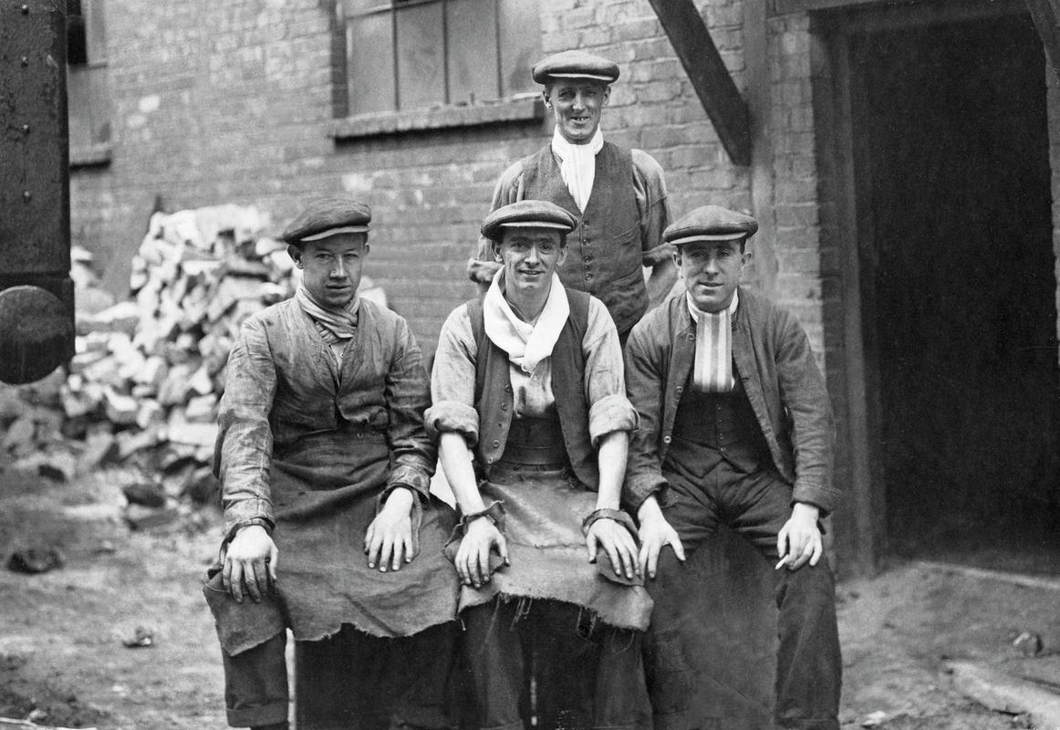 Group possibly showing bar cutters in a tinplate works and possibly at Dyffryn steel and tinplate works.