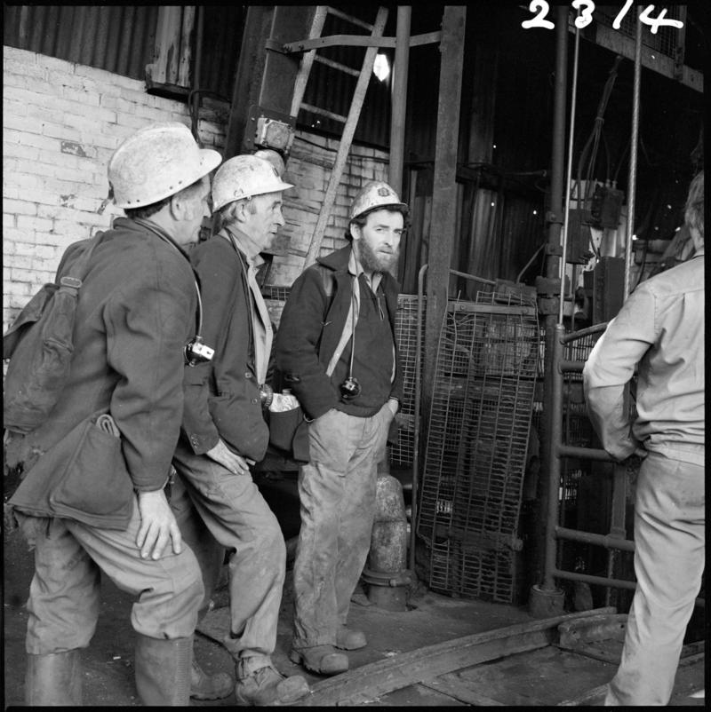 Black and white film negative showing miners waiting at pit top, Morlais Colliery 13 May 1981.  &#039;Morlais 13/5/81&#039; is transcribed from original negative bag.