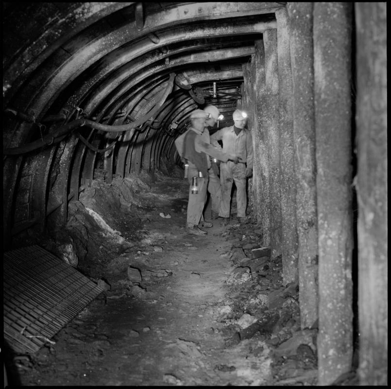 Colour film negative showing three men underground at Cwm Colliery.  &#039;Cwm&#039; is transcribed from original negative bag.