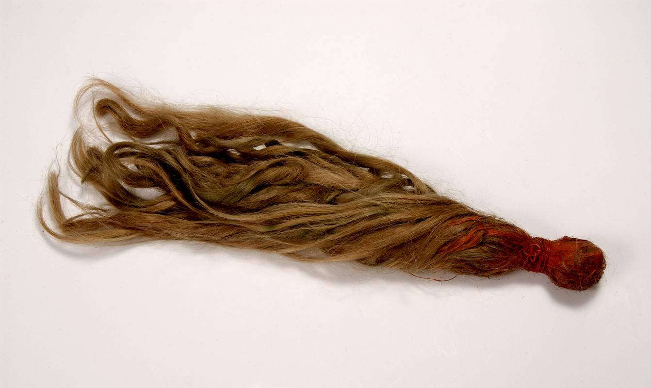 length of blonde hair bound at one end