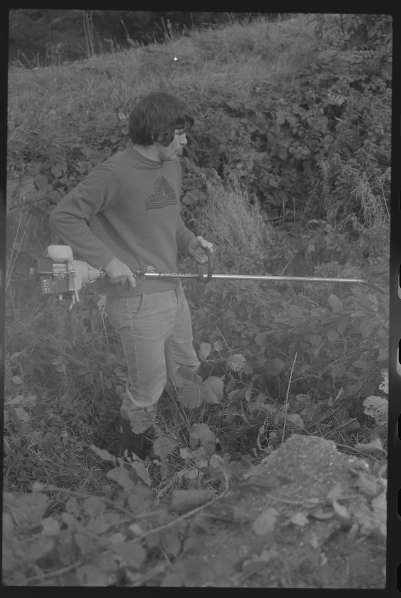 Man with strimmer, possibly a volunteer with Canal Society. Location unknown.