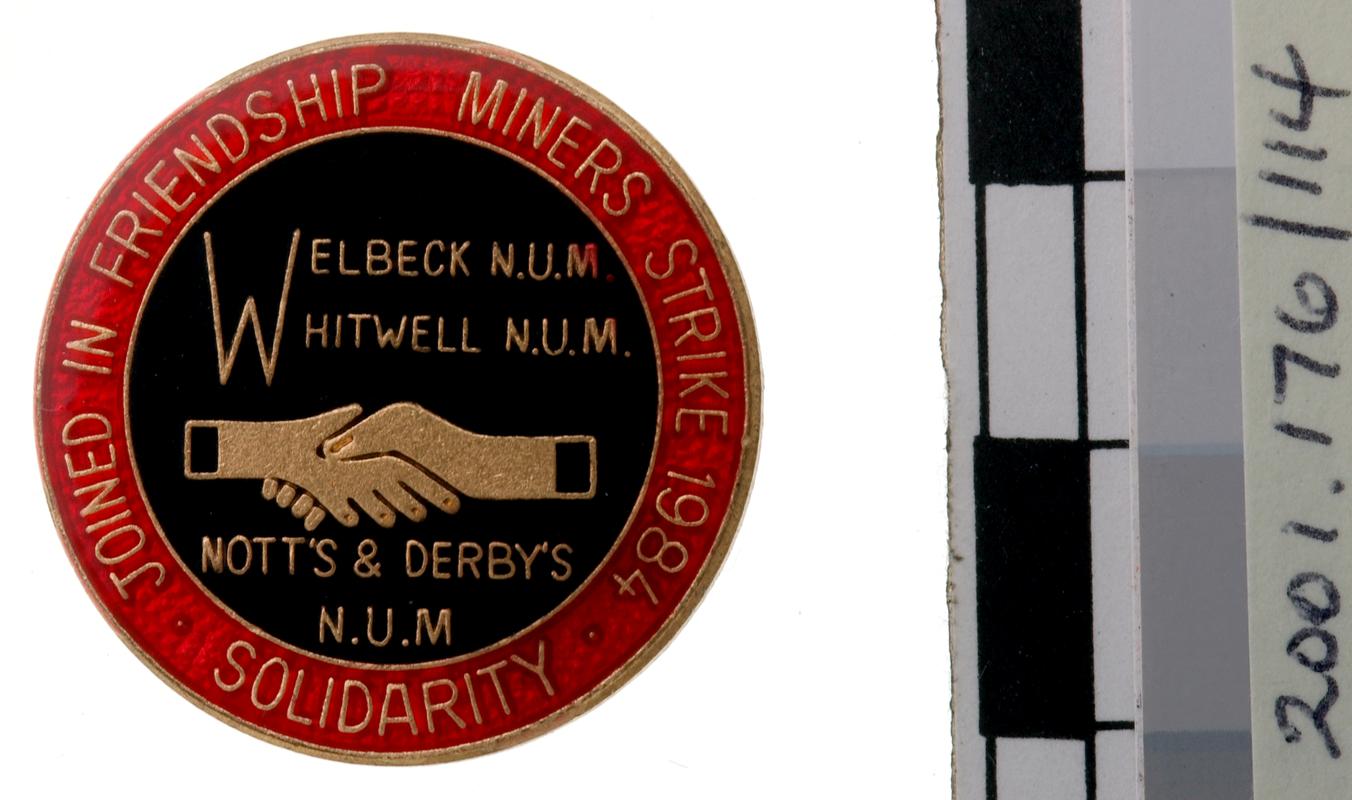 N.U.M badge