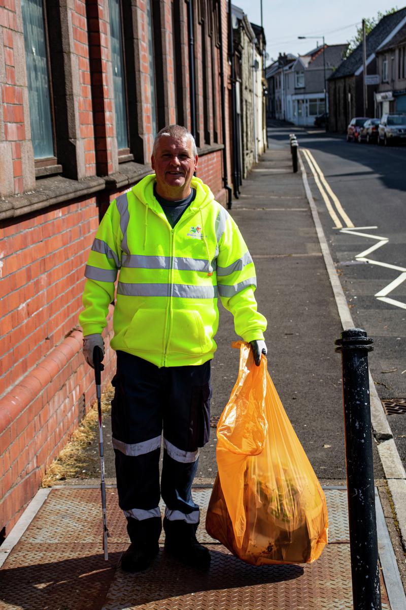Employee of Blaenau Gwent council keeping the streets clean throughout Blaenau Gwent during the pandemic .
