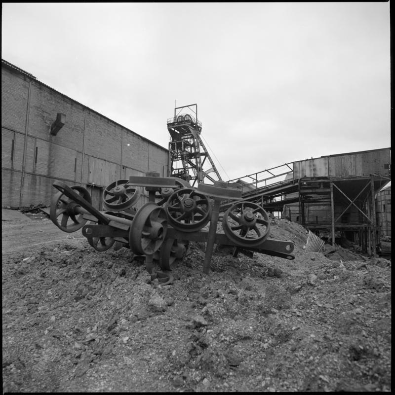 Black and white film negative showing a pile of wheels in the colliery yard, Deep Duffryn Colliery.  &#039;Deep Duffryn&#039; is transcribed from original negative bag.