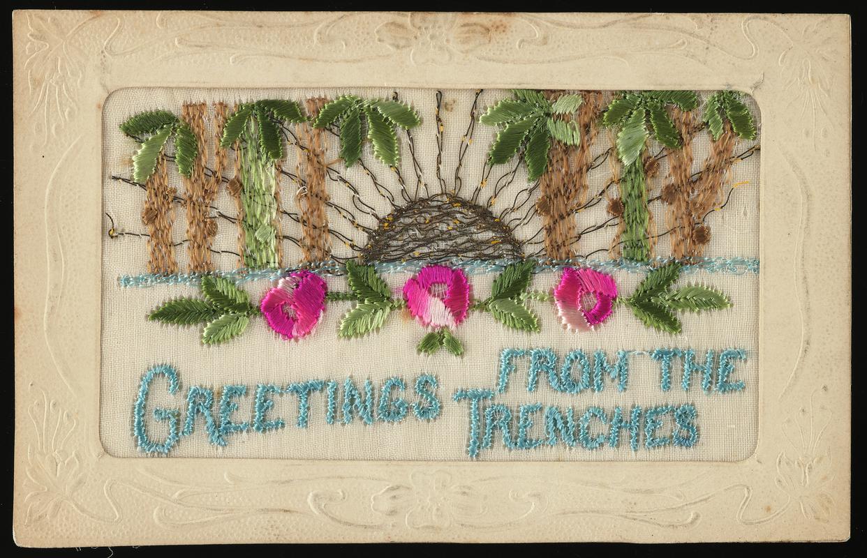Embroidered postcard inscribed &#039;GREETINGS FROM THE TRENCHES&#039;. Handwritten message on back. Probably sent to Miss Evelyn Hussey, sister of Corporal Hector Hussey of the Royal Welch Fusiliers, during the First World War.