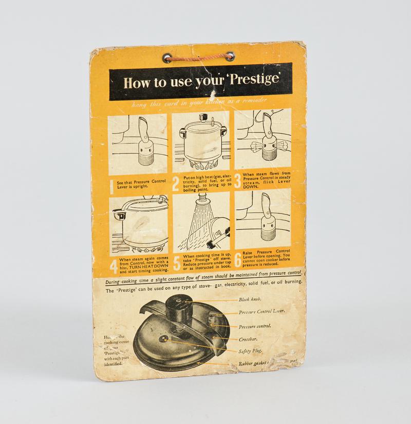 Instruction card &#039;How to Use your Prestige&#039; with orange cord tied through eyelets at top for hanging up.