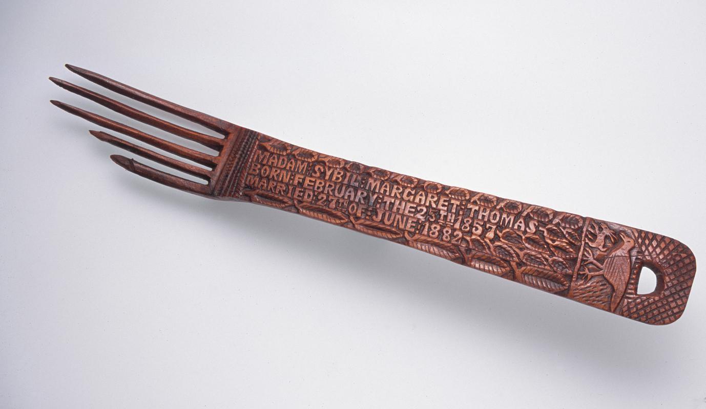 Carved fork with inscribed narrow panel handle