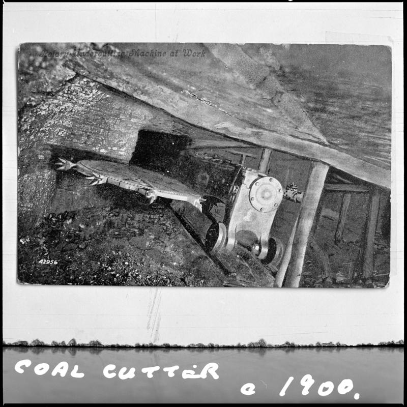 Black and white film negative of a photograph showing a coal cutter, unidentified colliery.  Image is photographed from a publication.  &#039;Coal Cutter c.1900&#039; is transcribed from original negative bag.
