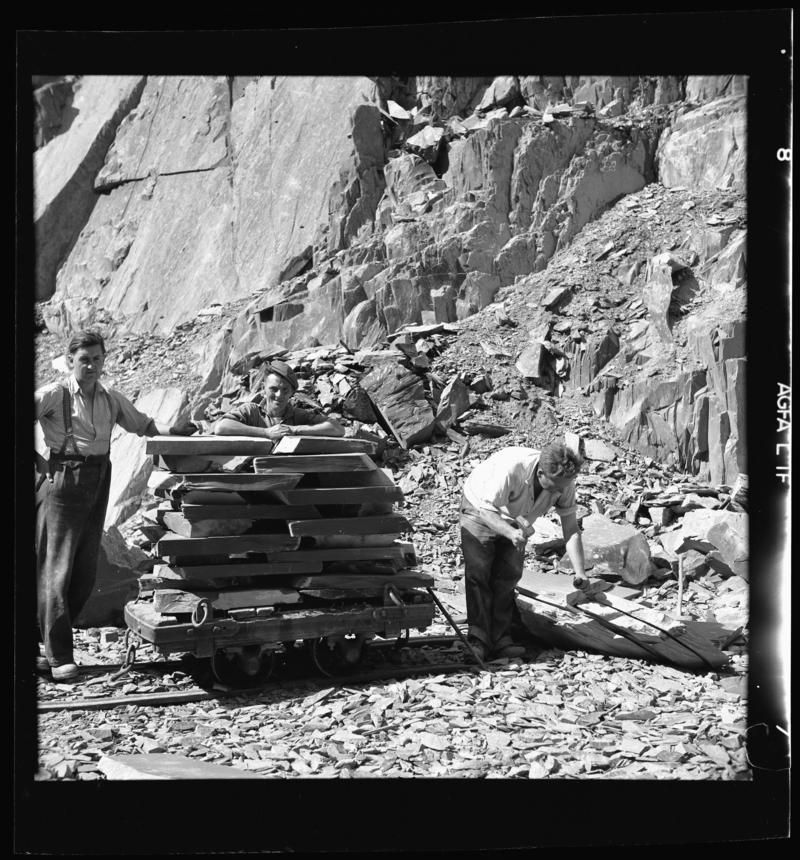 Quarrymen with a loaded &#039;flat car&#039; of slate - &#039;slediad&#039; - ready to be transported to the splitting and dressing sheds, Dinorwig Quarry, early 1960s.