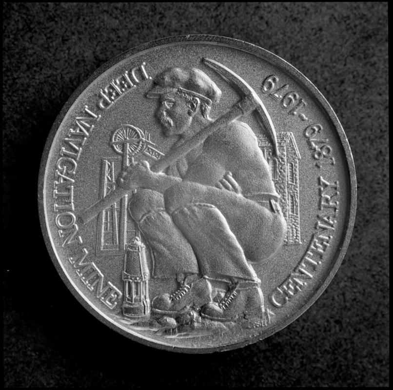 Black and white film negative showing a medallion commemorating the centenary anniversary of Deep Navigation Colliery, 1879-1979.