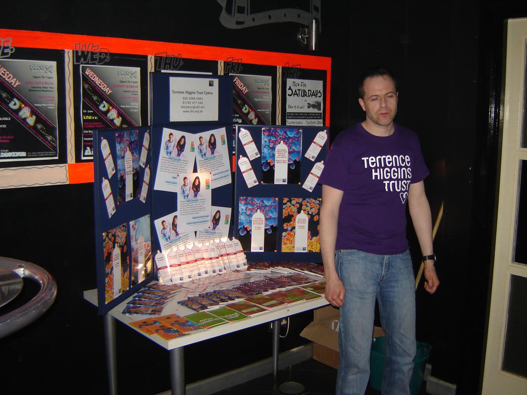 Wayne Curley, who worked for Terrence Higgins Trust Cymru, with a stand promoting safer sex.