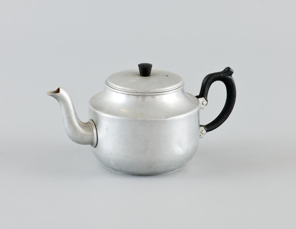 Aluminium teapot, with plastic handle and plastic handle on metal lid. Minor denting on the body of the teapot.