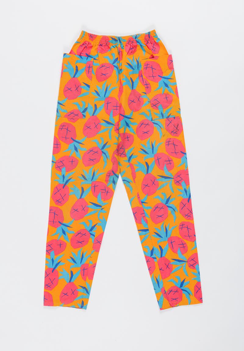 Orange, red and blue &#039;Pineapple design&#039; trousers worn by Thalia Campbell on the march from Cardiff to Greenham Common, 27 August - 5 September 1981.