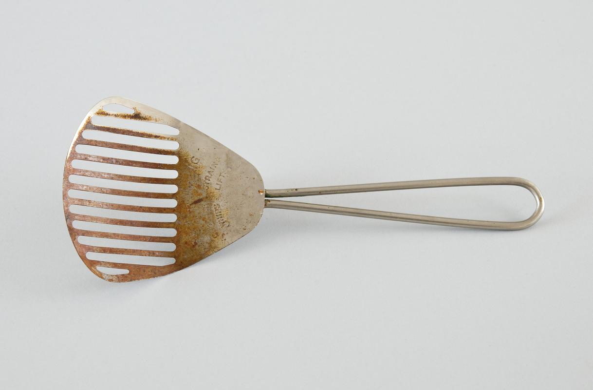 Fish slice?/ spoon like kitchen utensil with grilled scoop, made of stainless steel. Called KITCHAMAJIG.