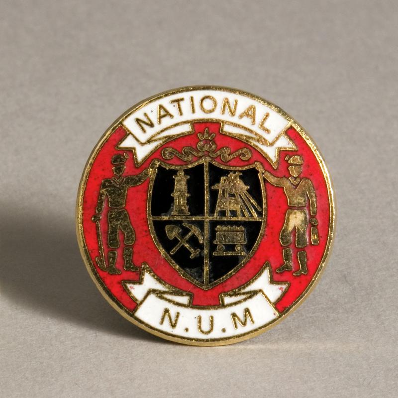 NUM badge (front)