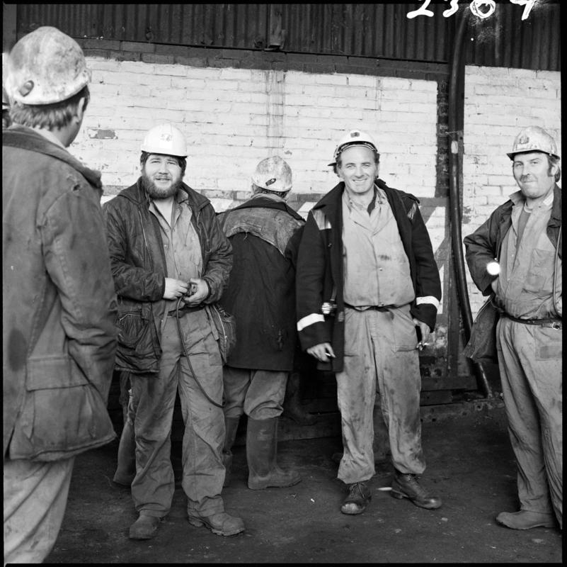Black and white film negative showing a group of miners, Morlais Colliery, 13 May 1981.  &#039;Morlais 13/5/81&#039; is transcribed from original negative bag.