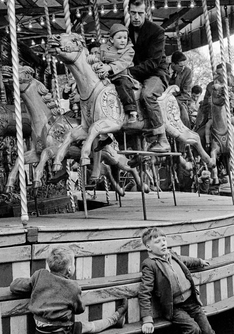 GB. ENGLAND. Hampstead. The annual bank holiday fair on Hampstead Heath in North London.The traditional Carousel. Taken on a Contax 2 camera (first professional camera). 1958.
