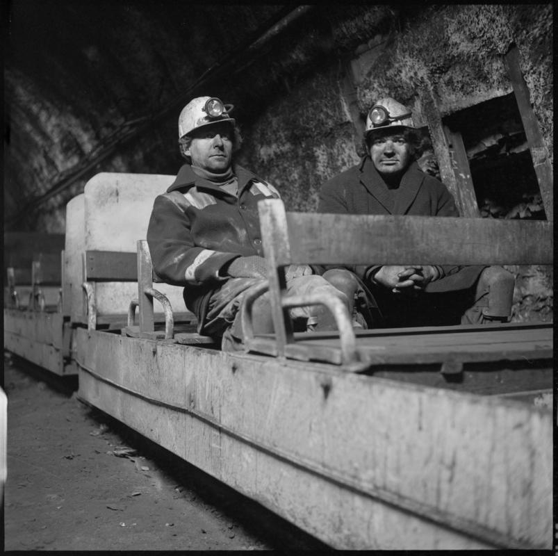 Black and white film negative showing two men on the manriding train, Wyndham Western Colliery. &#039;Wyndham&#039; is transcribed from original negative bag.