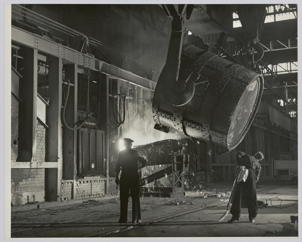 Charging open hearth furnace in the melting shop with liquid iron - Photograph of steelworks and South Wales