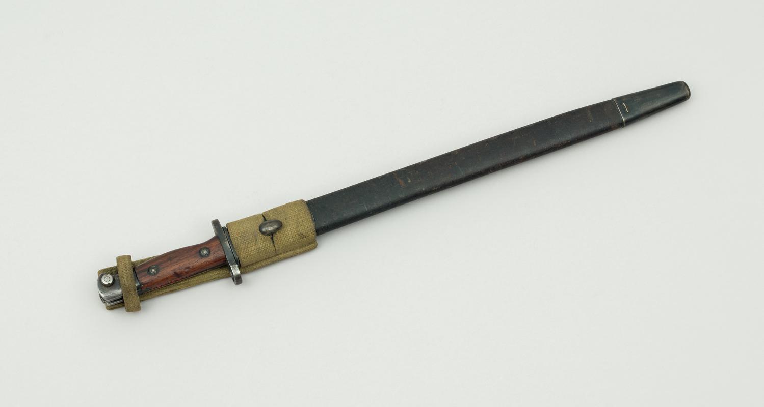 Enfield 17&#039;&#039; bayonet in leather scabbard. For use with an Enfield rifle. Used widely during the First and Second World Wars.