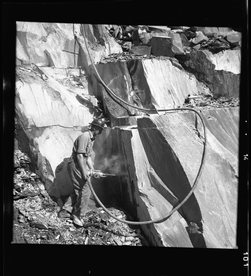 Close up view of a quarryman operating a rock drill, Dinorwig Quarry, early 1960s.