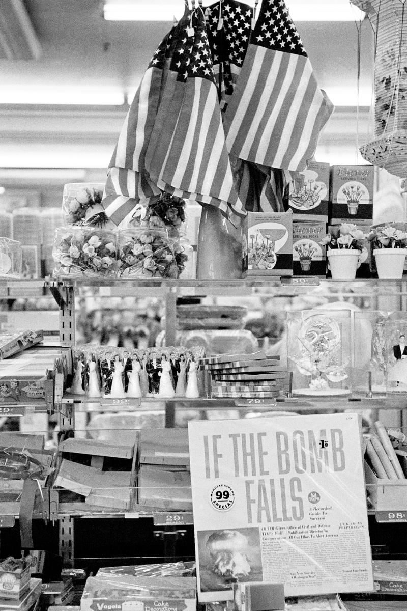 USA. NEW YORK. Lower Manhattan. Woolworth Shop &amp; Ban the Bomb record. Plus the American Flag. 1962.