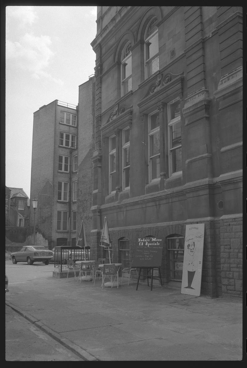 South east corner of Exchange Building, with tables belonging to the Exchange restaurant on pavement, Mount Stuart Square, Butetown.