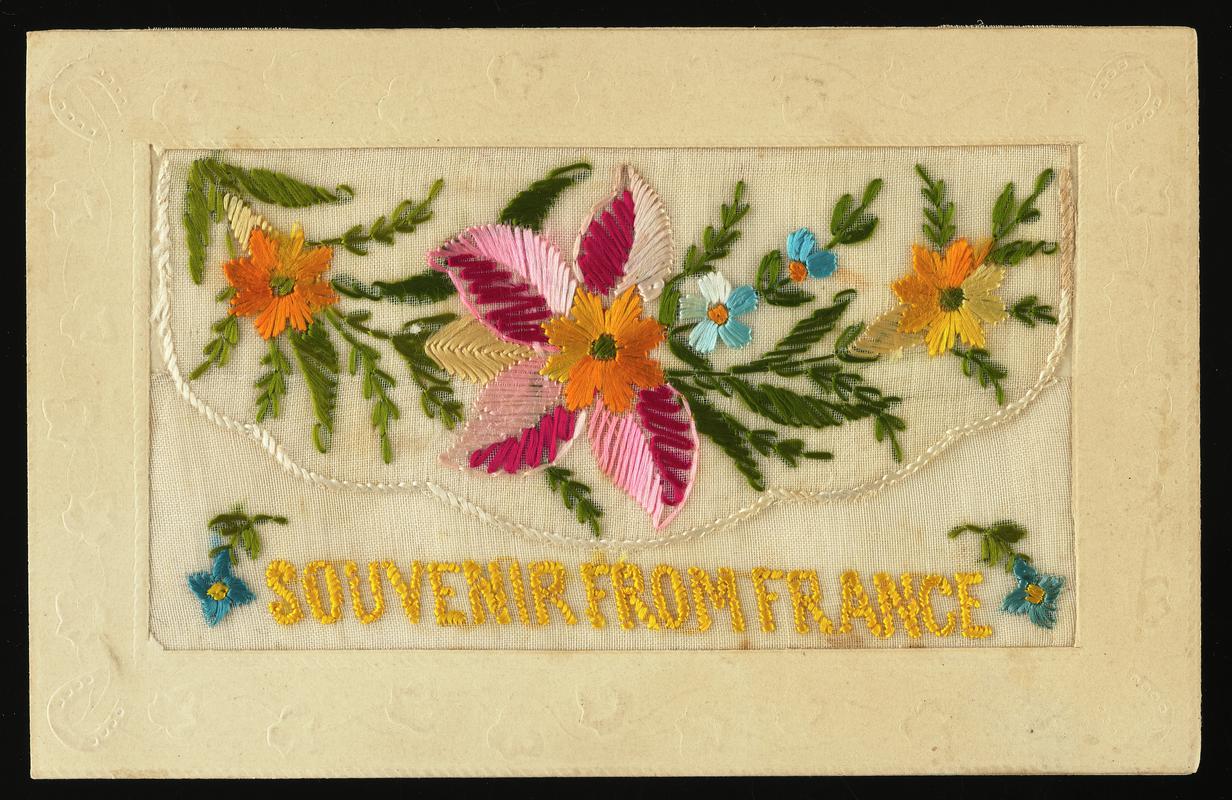Embroidered silk postcard inscribed Souvenir From France. Sent from France possibly by Gordon Hobbs or Tom Hardiman during First World War. Undated. Embroidered with sprays of flowers, red, gold and blue. Flap opening contains no card. No message on back.