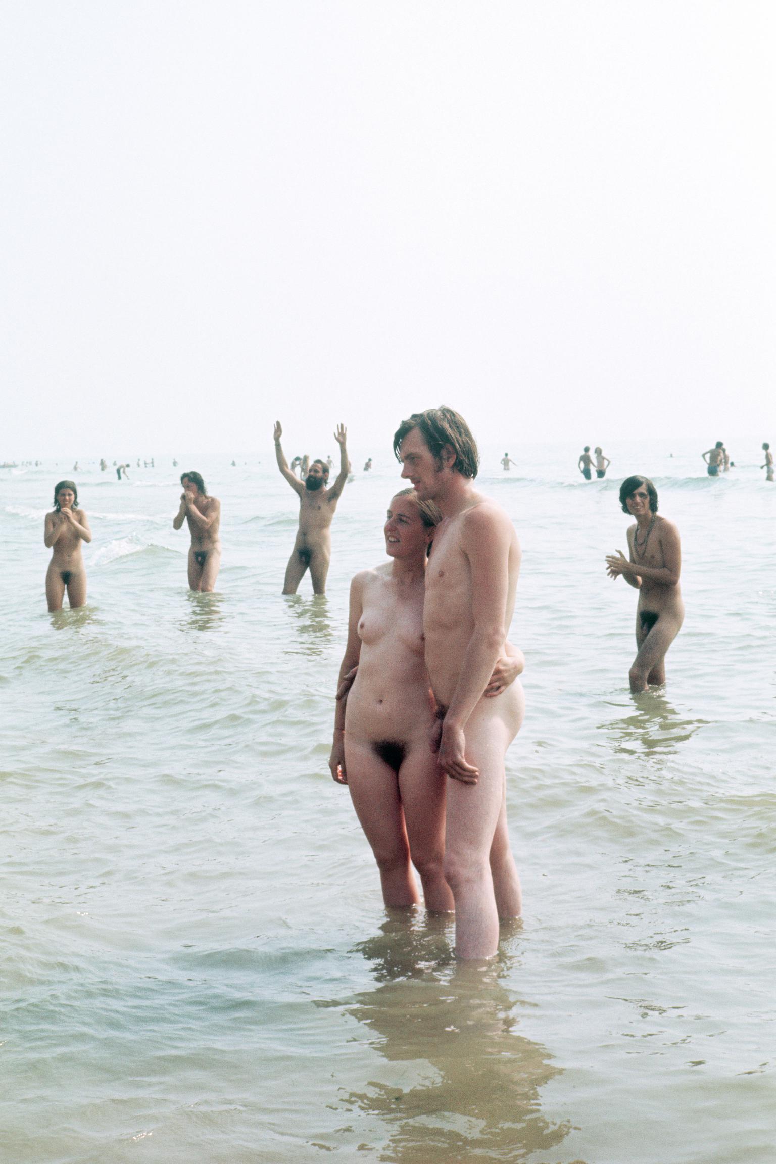 Isle of Wight Festival. A young couple posing naked in the sea
