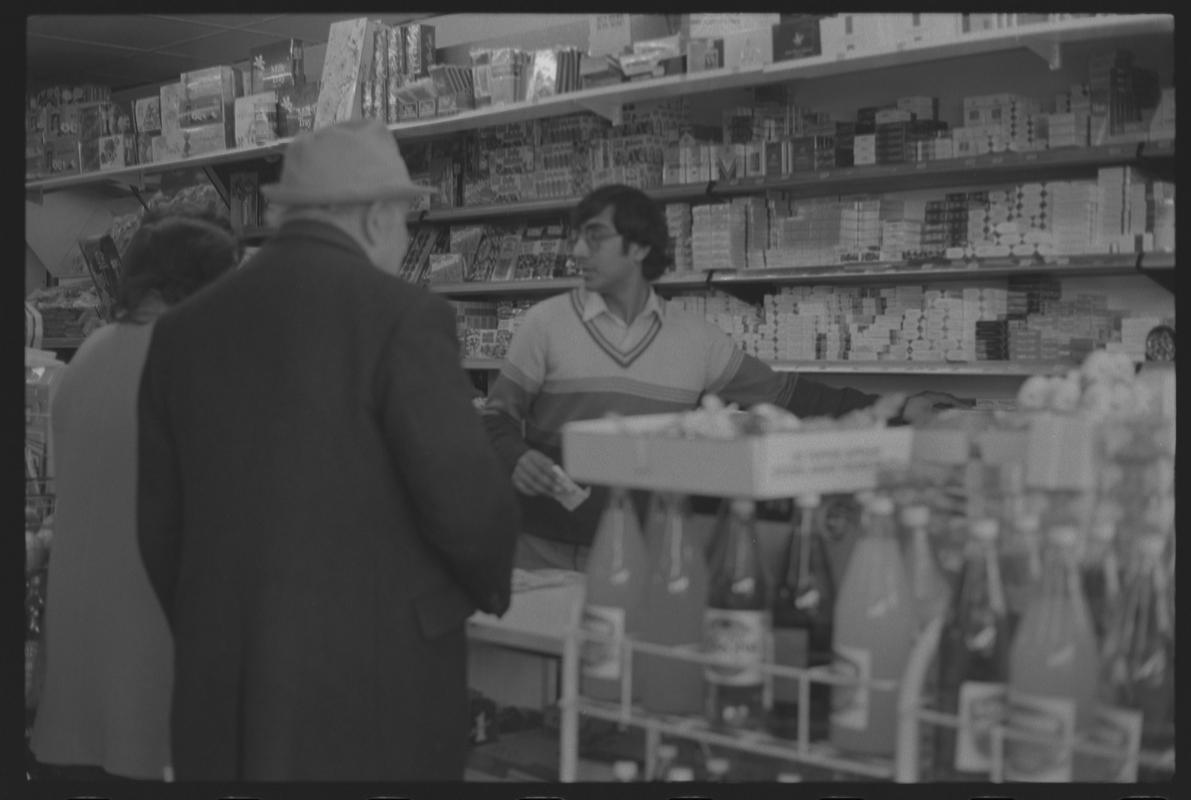 People at cigarette counter in supermarket, Loudoun Square, Butetown.