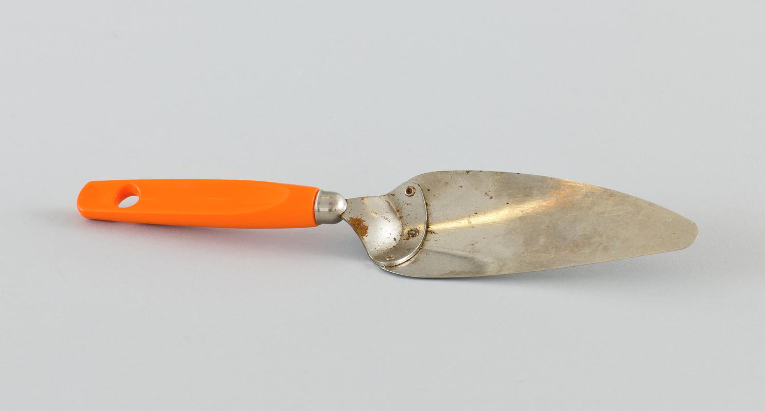 Pastry? knife with orange handle. Metal spatula blade with platic handle.