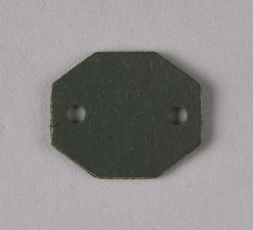 Small piece of plastic with holes.