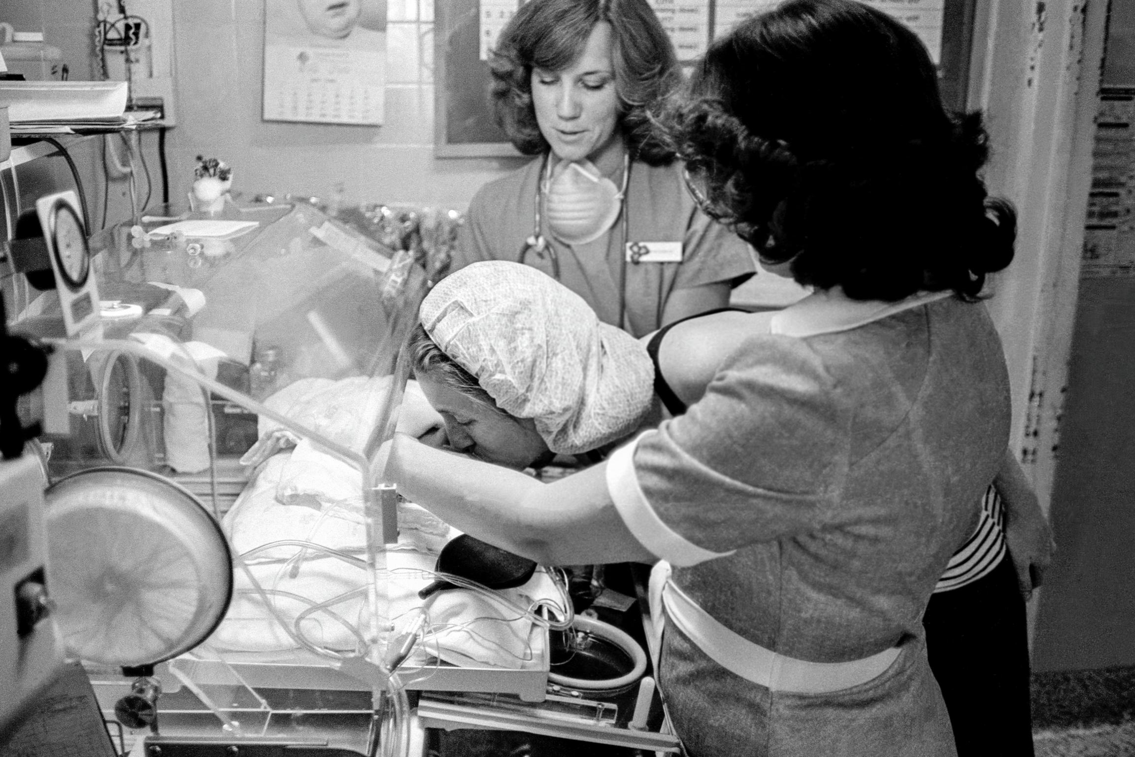 Preemie Baby unit at St Joseph's Hospital. The mother feels much closer to her daughter after the nurses opened the incubator (I.C.U.) for a kiss. Phoenix, Arizona USA