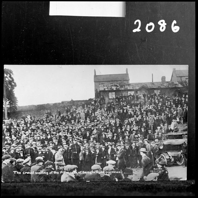 Black and white film negative of a photograph showing the scene at Universal Colliery, Senghenydd after the explosion of 14 October 1913.  Caption on photograph reads &#039;the crowd waiting at the pit mouth at Senghenydd for news&#039;.