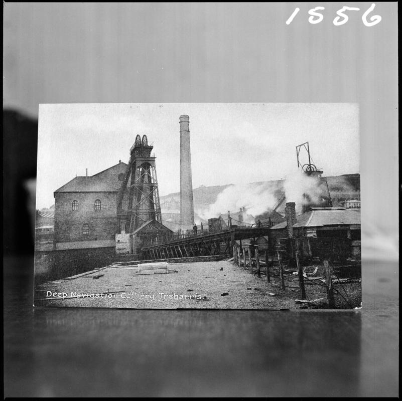 Black and white film negative of a postcard? showing a general surface view of Deep Navigation Colliery.  Bottom of postcard reads &#039;Deep Navigation Colliery, Treharris&#039;.  &#039;Deep Navigation&#039; is transcribed from original negative bag.