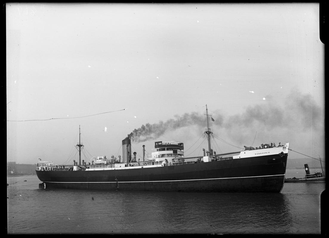 Starboard broadside view of S.S. DUBROVNIK and tug, c.1936.