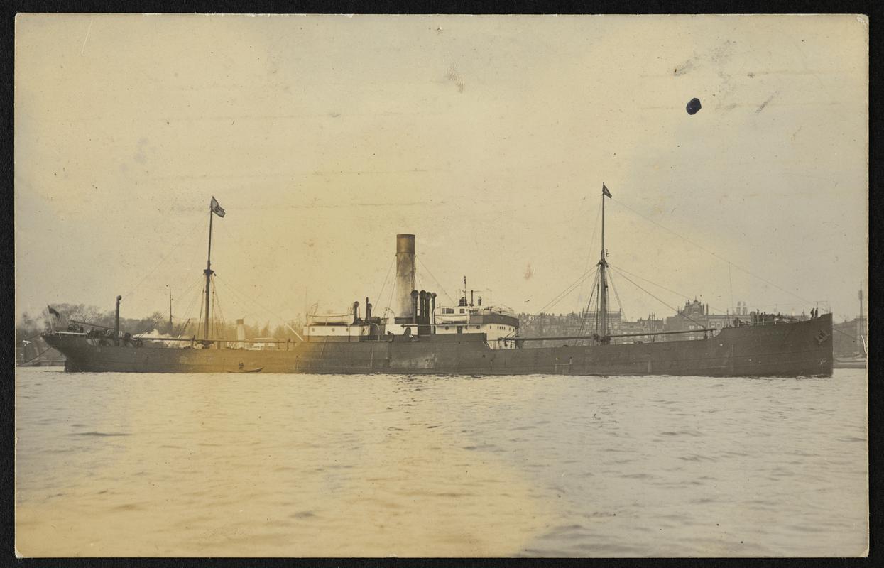 Real photograph postcard showing full starboard beam view of an unidentified tramp steamer at Rotterdam.
