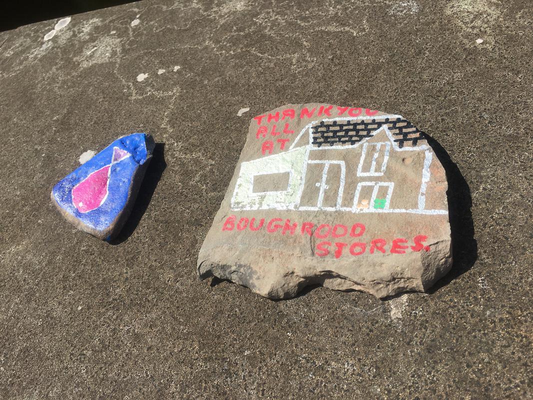 A pebble depicting a painting of Boughrood Stores reading &#039;Thank you all at Boughrood Stores&#039; on Boughrood Bridge, over the River Wye, Boughrood, Powys.