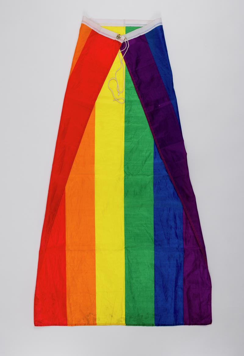 Pride rainbow flag worn as a cape by Numair Masud at various Pride&#039;s including first Welsh BAME Pride held on 10 August 2019.