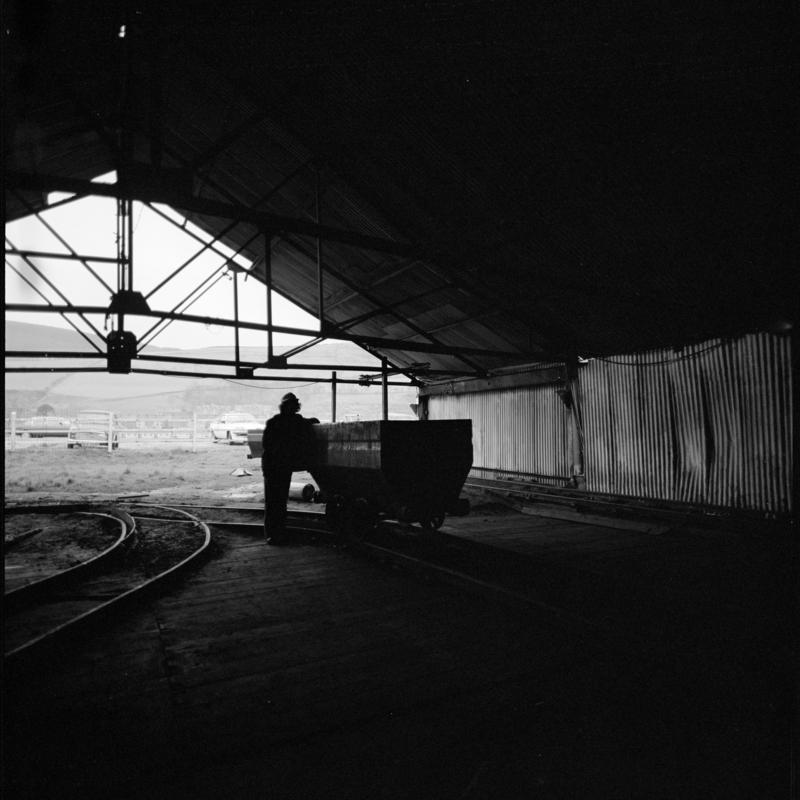 Black and white film negative showing man at the tub circuit, Coegnant Colliery 25 November 1981.  &#039;25 Nov 1981&#039; is transcribed from original negative bag.