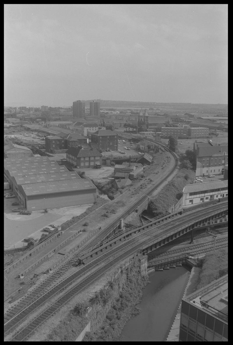 View of Butetown, with railway junction for Bute Road and docks feeder in foreground, and Penarth Head with Loudoun Square Flats in background.